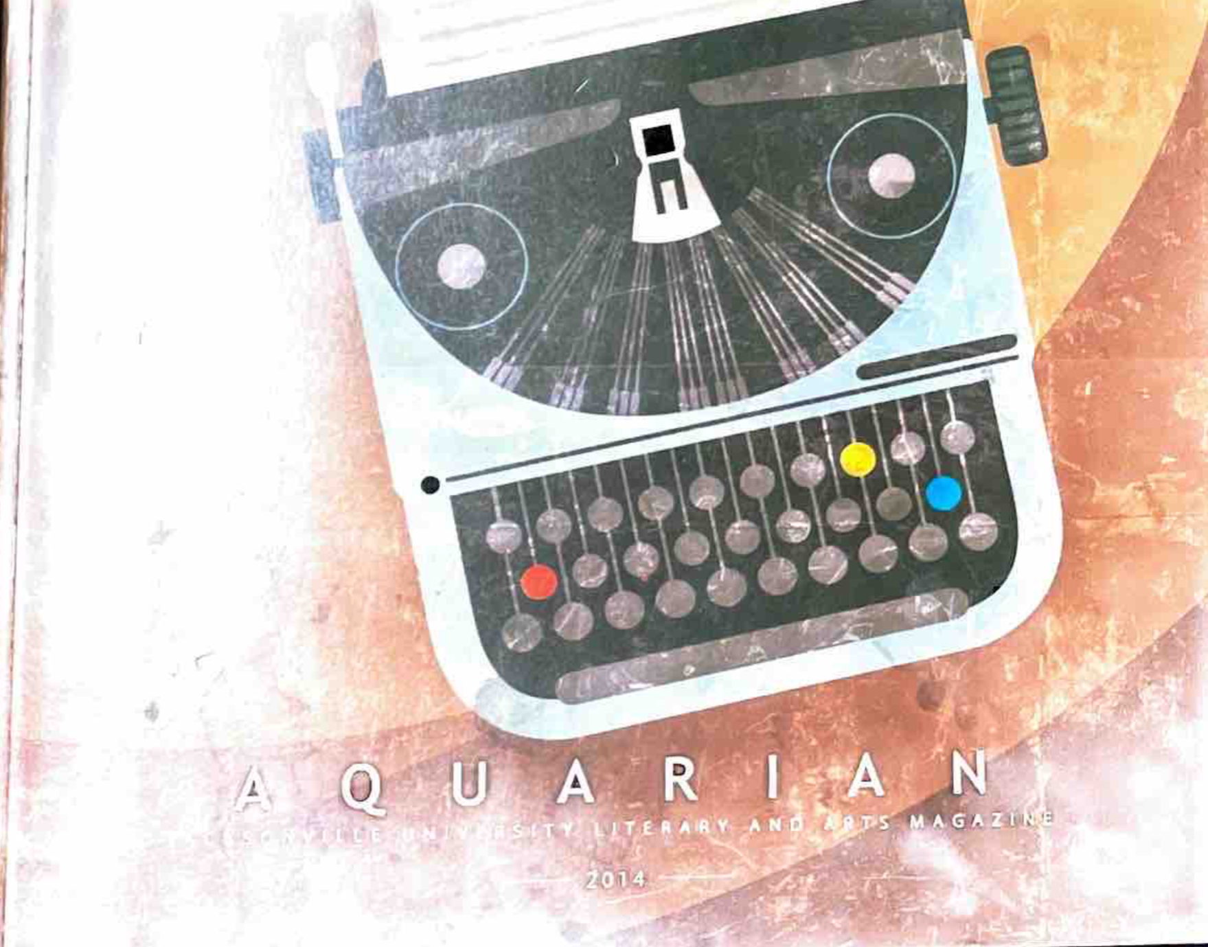 2014 Aquarian 2014 Cover with a grey and blue typewriter, a brown background,and the Title Aquarian