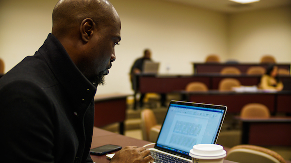 A student learning at his laptop in class.
